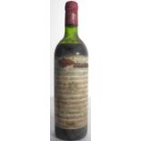 A bottle of Chateau Mouton Rothschild 1977. (The Queen Elizabeth the Queen Mother label in poor