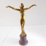 An Art Deco style and period gilt-bronze standing female figure – in stylised pose with outstretched