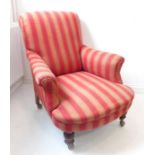 A late 19th century striped upholstered armchair on turned front legs with later castors