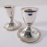 A pair of sterling silver dwarf candlesticks