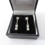 A fine pair of 18-carat white gold diamond earrings – each with three old-cut diamonds on white gold