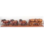 A large and unusual oak carving of a team of six Shire horses, driver and dray carrying three oak