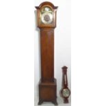 An oak-cased grandmother clock and a mahogany barometer. The clock's dial signed 'Tempus Fugit'