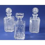 Three fine quality hand-cut spirit decanters of square form and with canted corners