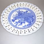 A circa 1910 Japanese porcelain plate. The reticulated border surrounding central decoration of a
