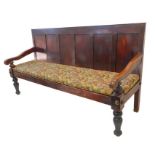 A large late 19th century stained-pine settle – six-panel back above downward swept shaped arms,