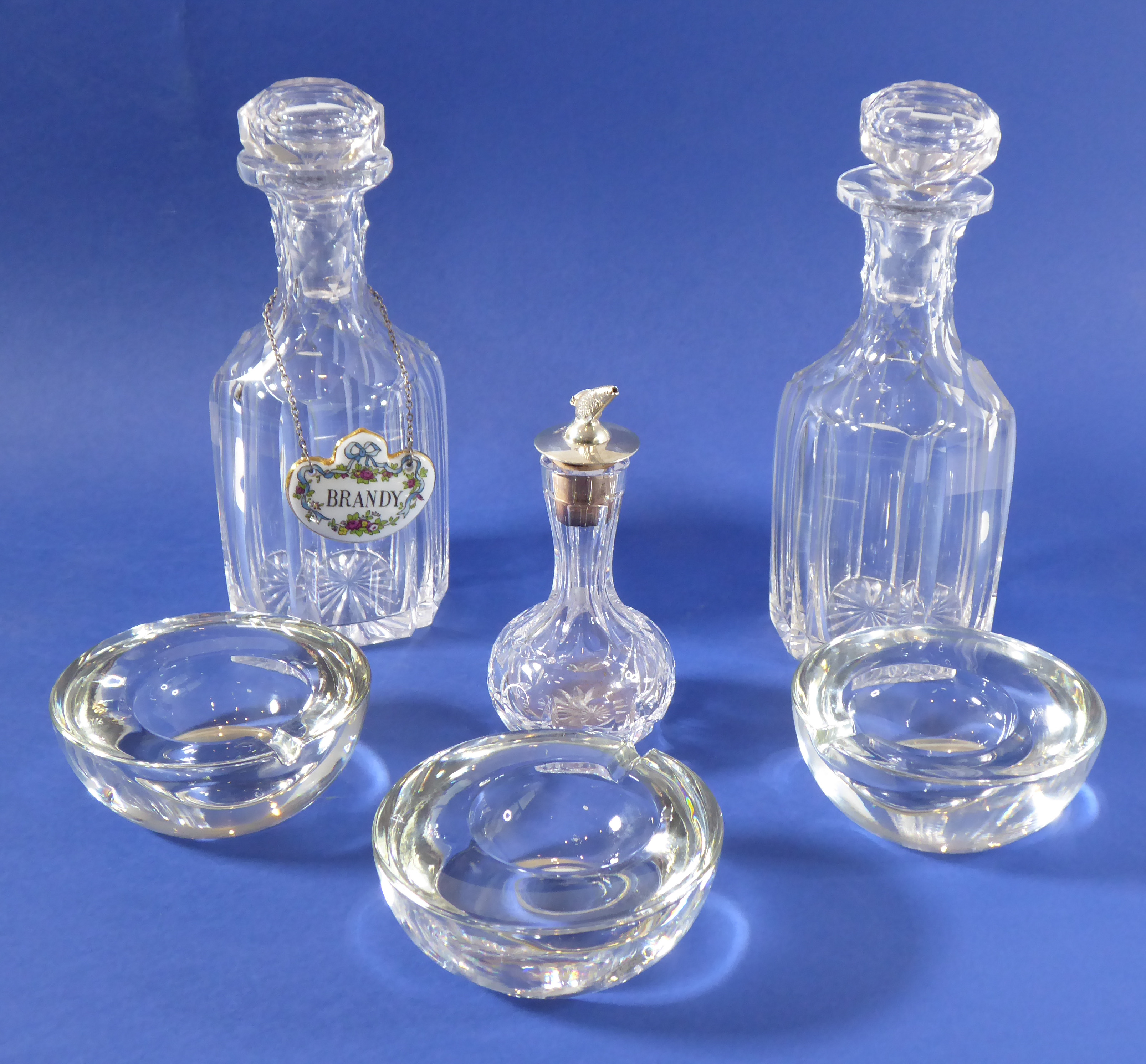 A pair of hexagonal cut-glass decanters (one with Crown Staffordshire 'Brandy' label), together with