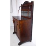 A late Regency period rosewood chiffonier; the carved crested galleried top with mirrored back above