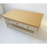 A Laura Ashley coffee table –  natural oak top overhanging three white-painted side-drawers and