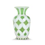 VASE "OVERLAY" de forme balustre en opaline verte doublée d'émail blanc taillé à décor découpé de