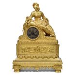 PENDULE "À LA SULTANE" en bronze doré représentant Vassiliki assise, appuyée sur un large coussin,