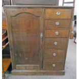 EARLY 20TH CENTURY MAHOGANY CABINET WITH PANEL DOOR OPENING TO RAILED INTERIOR AND 6 DRAWERS TO