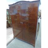 WALNUT 2 DOOR WARDROBE WITH RAILED INTERIOR ON SHAPED SUPPORTS,