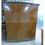 EARLY 20TH CENTURY BOW FRONT INLAID MAHOGANY TRIPLE DOOR WARDROBE WITH FITTED INTERIOR ON SQUARE