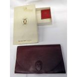 LES MUST DE CARTIER BURGUNDY CALFSKIN CLUTCH BAG Condition Report: Overall in good