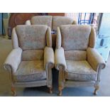 PAIR OF OVERSTUFFED ARMCHAIRS ON SHAPED SUPPORTS,