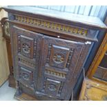 19TH CENTURY CARVED OAK CABINET WITH 2 CARVED PANEL DOORS OVER 2 DRAWERS 180CM TALL X 105CM WIDE