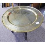 EASTERN BRASS TOPPED TABLE WITH ENGRAVED DECORATION & FOLDING BASE - 56CM DIAMETER