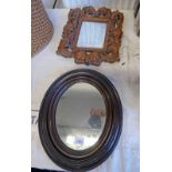 OVAL MAHOGANY FRAMED WALL MIRROR & A CARVED OAK FRAMED WALL MIRROR