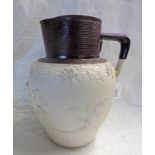 19TH CENTURY STONEWARE JUG WITH BROWN RIBBED RIM & CHERUB DECORATION - 29CM TALL