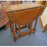 OAK DROP LEAF TABLE ON TURNED SUPPORTS Condition Report: Top and flaps are stained,