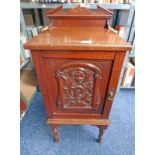 LATE 19TH CENTURY MAHOGANY CABINET WITH CARVED DOOR ON TURNED SUPPORTS