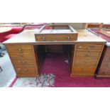 OAK DESK CIRCA 1900 WITH CENTRALLY SET DRAWER FLANKED BY 4 DRAWERS EACH SIDE AND PANEL DOORS ON