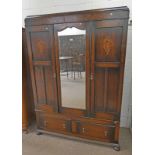 EARLY 20TH CENTURY OAK 2 DOOR WARDROBE WITH MIRROR OVER BASE WITH 2 DRAWERS ON BALL SUPPORTS WIDTH