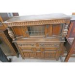 OAK ERCOL STYLE SIDEBOARD WITH CARVED DECORATION LEADED GLASS DOOR OVER 2 DRAWERS WITH 2 PANEL