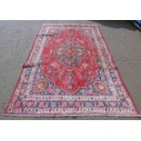 RED GROUND PERSIAN MARSHAD CARPET WITH CENTRAL MEDALLION FLORAL PATTERN 310 X 205CM