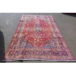RICH RED GROUND PERSIAN MARSHAD CARPET IN SOFT BLUE SURROUNDED BY A FLORAL PATTERNED BORDER 280 X