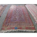 RED GROUND MIDDLE EASTERN RUG 280 X 170 CM Condition Report: Wear and marks present.