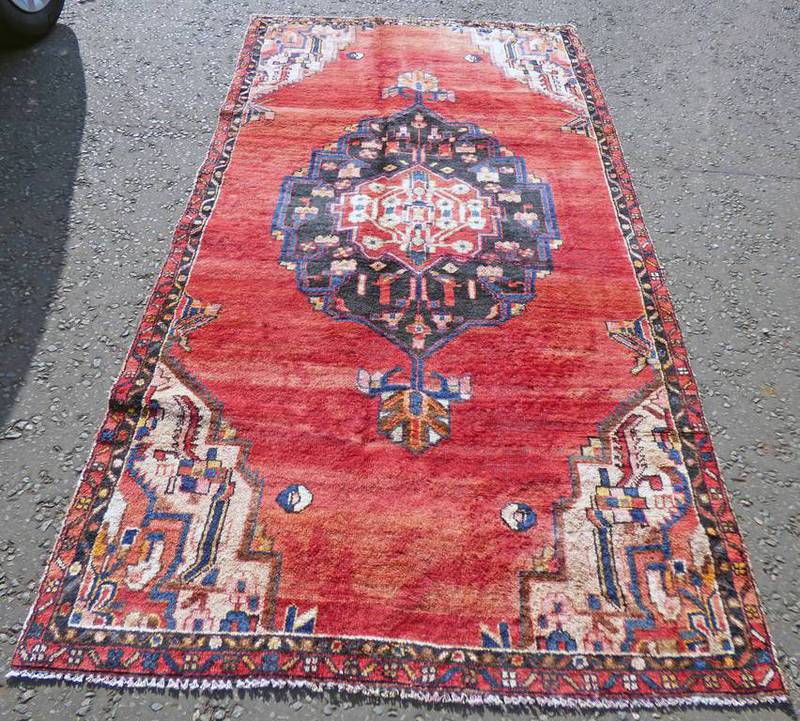 WASHED RED GROUND PERSIAN SAROUK RUG WITH A LARGE CENTRAL MEDALLION 270 X 132CM Condition