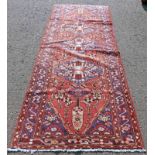 RED AND BLUE GROUND IRANIAN RUNNER WITH FLORAL MEDALLION DESIGN 296 X 115CM Condition