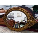 LATE 20TH CENTURY GILT ENCRUSTED OVAL WALL MIRROR,
