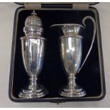 CASED SILVER SUGAR CASTOR & CREAM JUG WITH PANELLED SIDES ON CIRCULAR BASES BY WALKER & HALL