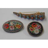 2 FLORAL MOSAIC BROOCHES & A SILVER GILT FINGER GUARD BROOCH WITH ENAMEL,