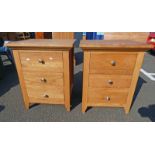 PAIR OF OAK BEDSIDE CHESTS OF 3 DRAWERS ON TAPERED SUPPORTS .
