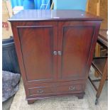 MAHOGANY CABINET WITH 2 PANEL DOORS OVER SINGLE DRAWER ON BRACKET SUPPORTS.