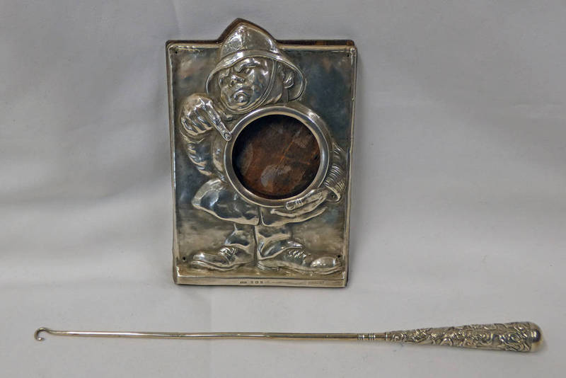 SILVER NOVELTY WATCH HOLDER IN THE FORM OF A POLICEMAN AND CHINESE SILVER BUTTONHOOK MARKED WH90