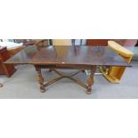 20TH CENTURY OAK EXTENDING DINING TABLE ON TURNED SUPPORTS,