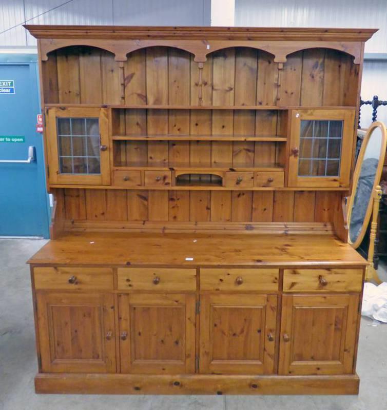 PINE DRESSER WITH 2 GLASS PANEL DOORS AND 2 DRAWERS OVER BASE OF 4 DRAWERS OVER 2 PANEL DOORS,