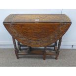 CARVED OAK SUTHERLAND TABLE ON TURNED SUPPORTS,