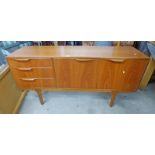 TEAK SIDEBOARD OF 3 DRAWERS AND 2 PANEL DOORS ON TAPERED SUPPORTS,