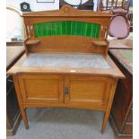LATE 19TH CENTURY OAK WASHSTAND WITH GALLERY TOP WITH TILE INSERT OVER BASE OF 2 PANEL DOORS WITH