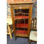 EARLY 20TH CENTURY OAK DISPLAY CABINET WITH ASTRAGAL GLASS PANEL DOOR ON BARLEY TWIST SUPPORTS.