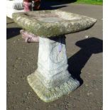 RECONSTITUTED STONE BIRD BATH WITH ORIENTAL DECORATION,