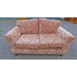 OVERSTUFFED 2 SEATER SETTEE WITH RED & GOLD PATTERN