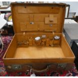 EARLY 20TH CENTURY LEATHER TRAVELLING CASE WITH SILVER PLATED CONTAINERS IN ITS FITTED INTERIOR