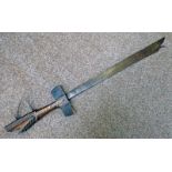 TRIBAL SWORD WITH 60CM LONG BLADE WITH SHAPED TIP WITH CARVED WOODEN GRIP WITH BRASS PLAQUE MARKED